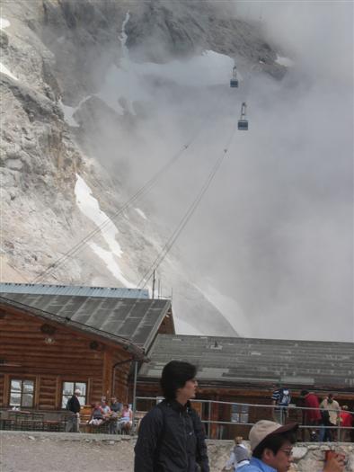 The cable car to the top emerges from the cloud